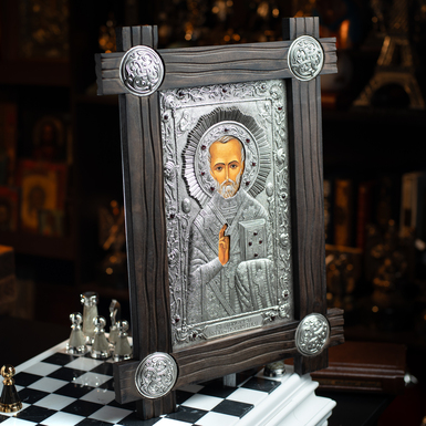 Icon of St. Nicholas the Wonderworker with silver plating in a wooden frame
